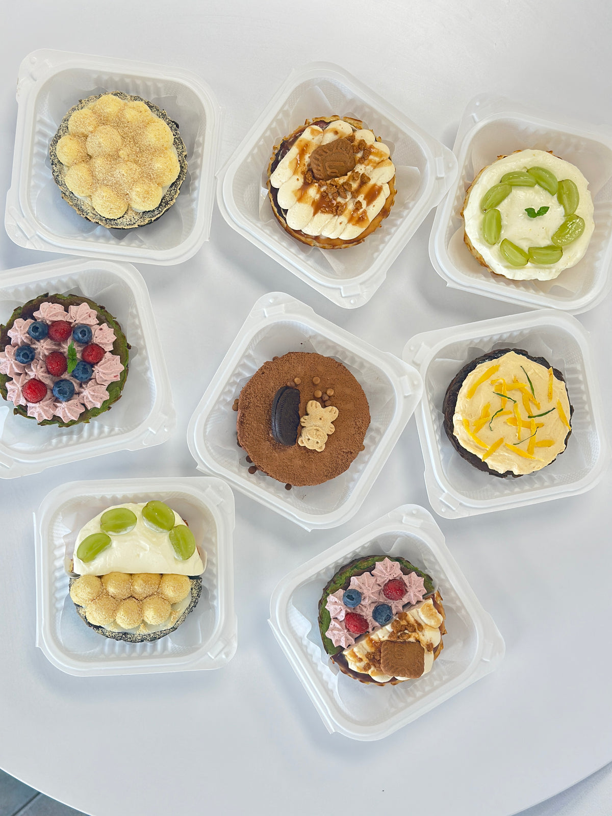 Assortment of decorated Basque cheesecakes