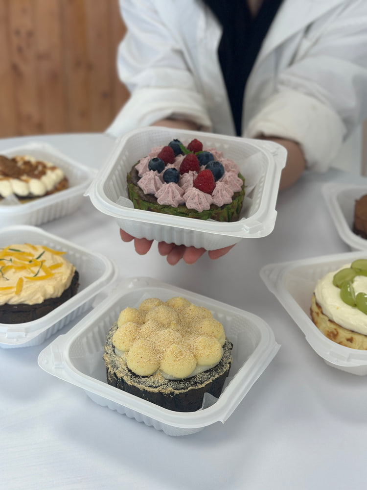 Berry-topped Basque cheesecake in a serving box