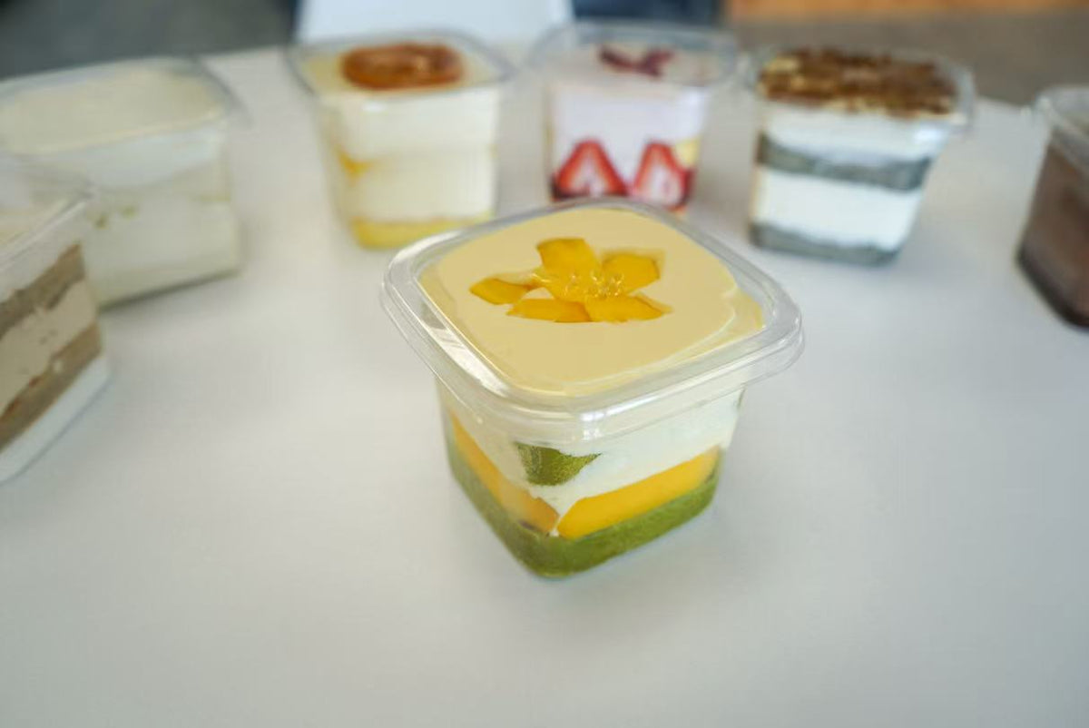 Fruit-topped chiffon dessert box with cream layers