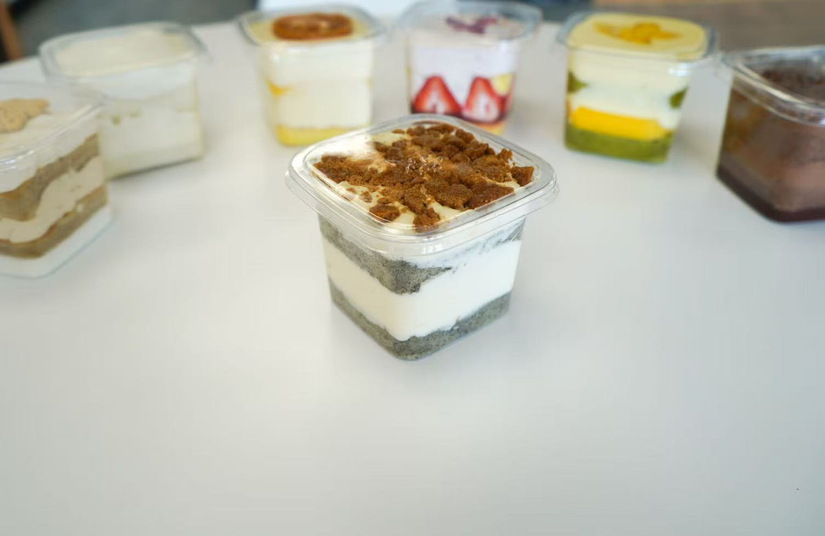 Layered chiffon dessert box with cream and topping